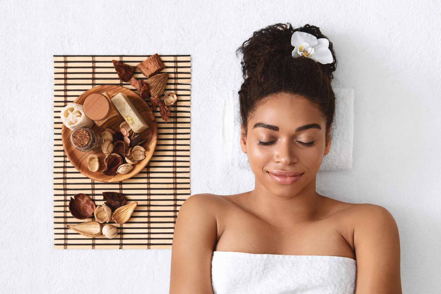 Peaceful black girl having aromatherapy at spa