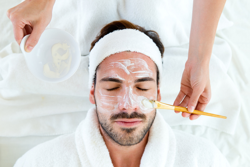 Man with Clay Facial Mask in Beauty Spa